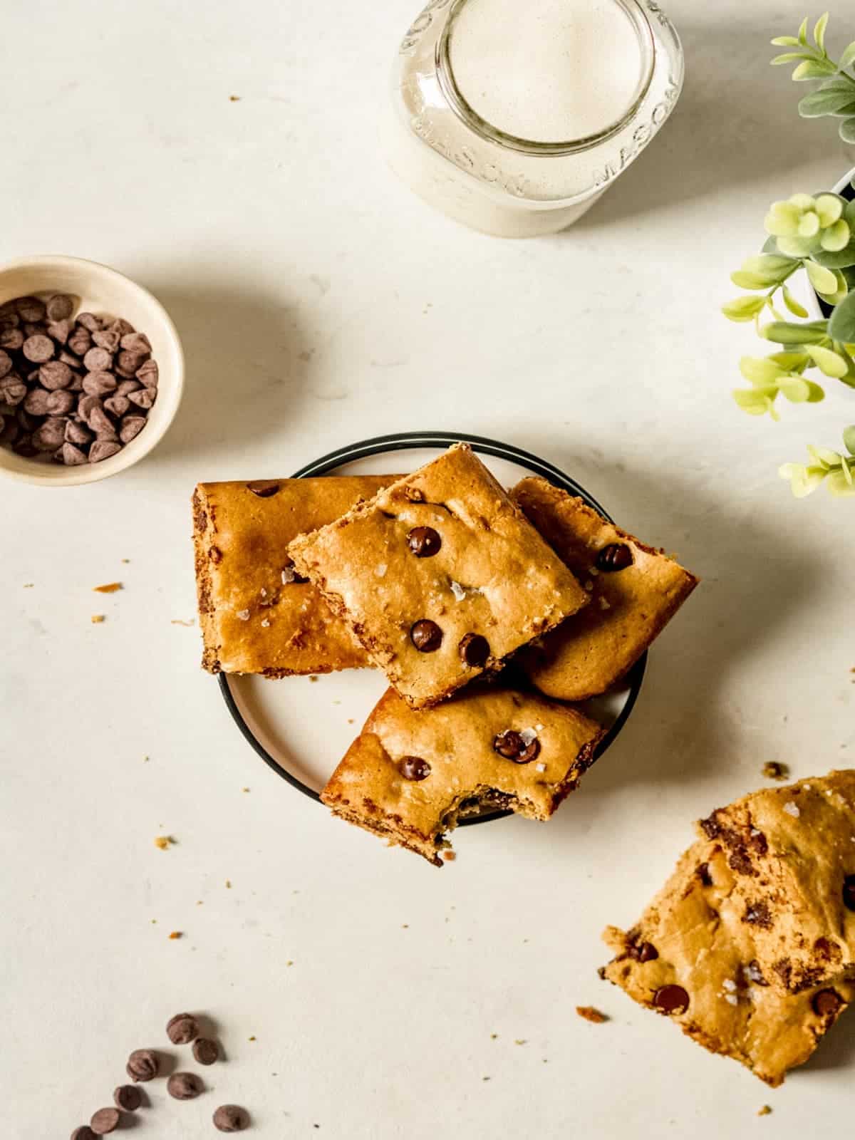 A plate of tahini cookie bars on a white table.