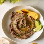 A white bowl filled with avocado black bean dip.