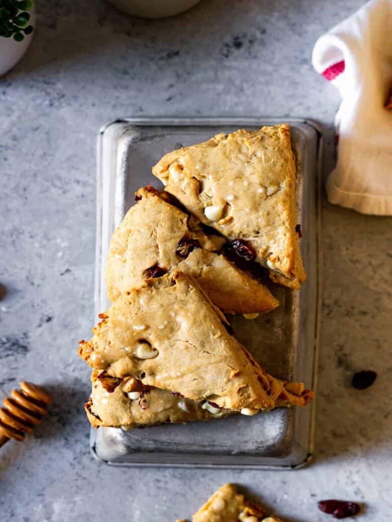 White chocolate cranberry scones on an upside-down vintage loaf pan.