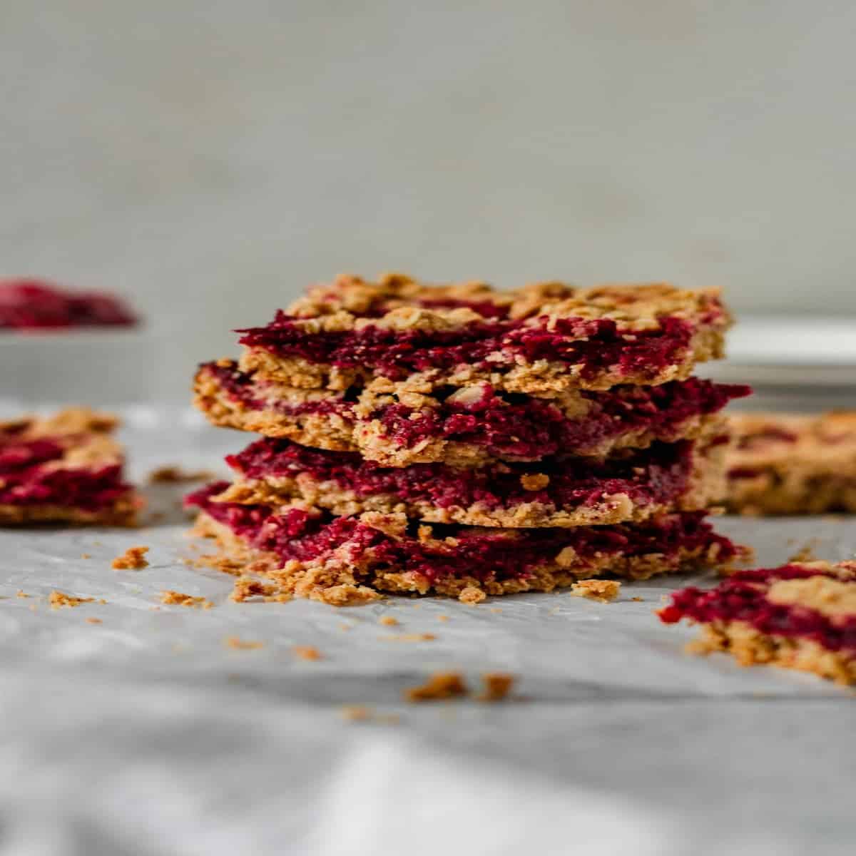 four oatmeal bars filled with raspberry stacked
