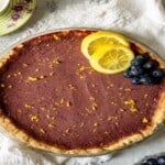 lemon blueberry tart topped with lemon slices and blueberries