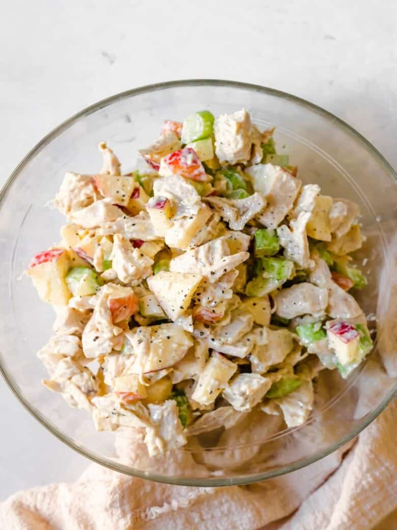 Chicken apple salad in a glass bowl.