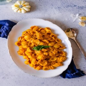 pumpkin pasta on a serving dish with a spoon