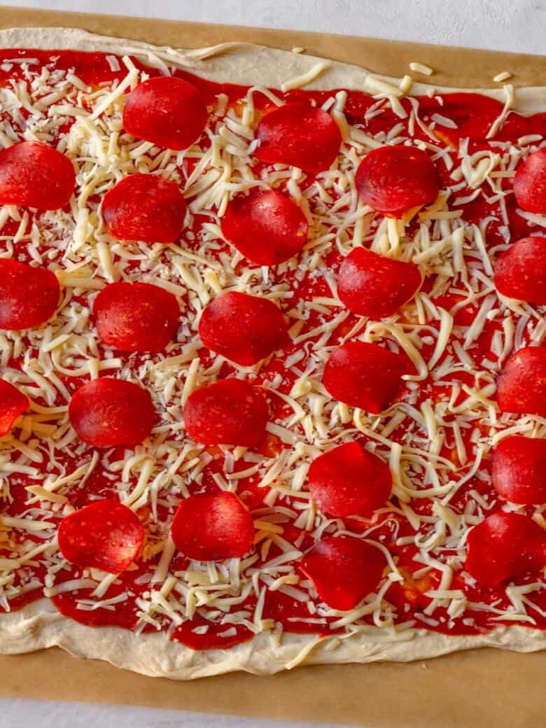 Pizza dough with toppings before it is baked.
