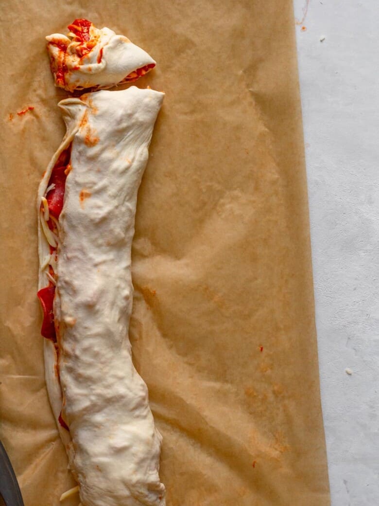 Pizza dough rolled up and cut into slices.