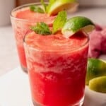 Two frozen strawberry moscow mules on a white platter.