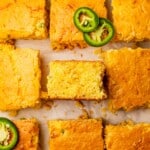 Cornbread cut into pieces with one laying on its side.