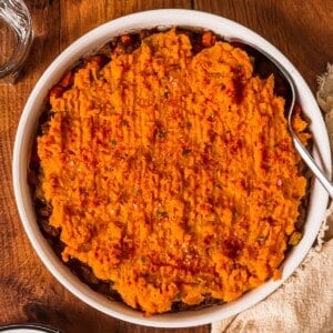 Casserole dish full of beef and sweet potato pie.