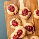 Thumbprint cookies on a cutting board.