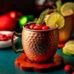 Cranberry moscow mule on a green table.