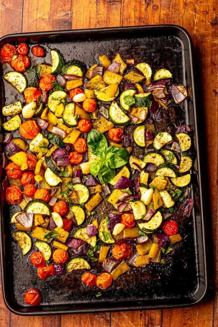 A sheet pan of roasted vegetables on a table.