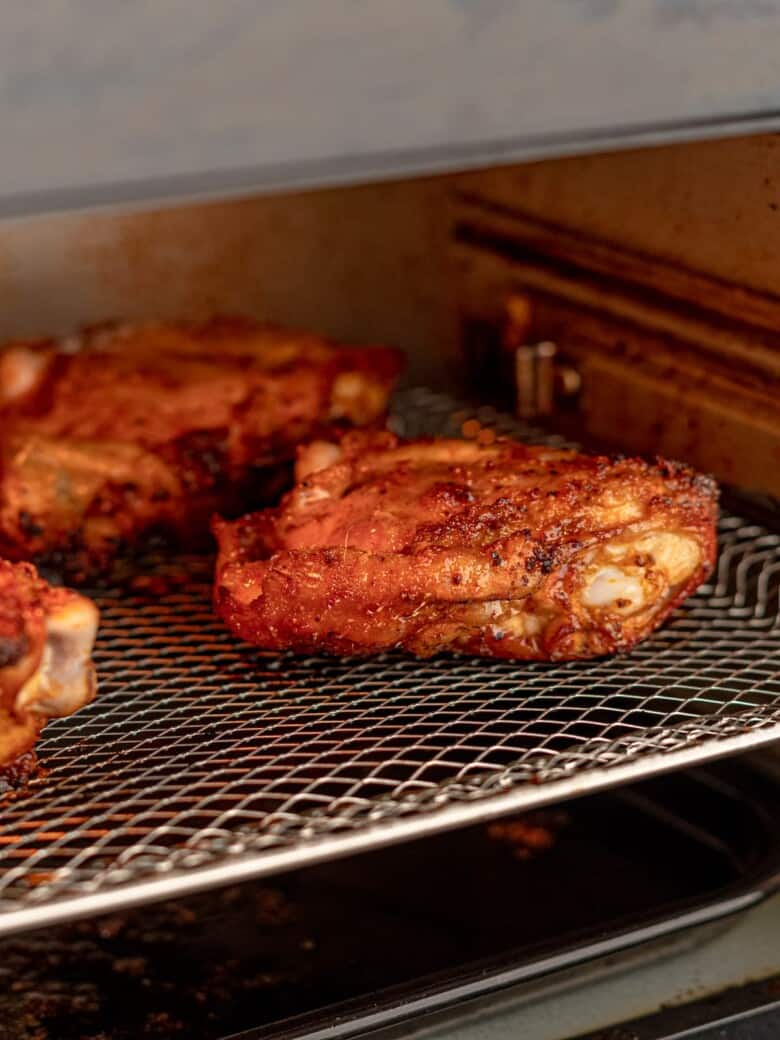 Chicken thighs in an air fryer.