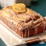 Lemon drizzle cake topped with lemon slices.