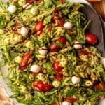 Pesto pasta salad topped with balsamic glaze.