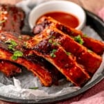 A rack of ribs on a platter.