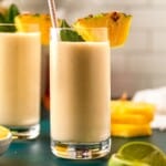 A pina colada with a pineapple wedge as garnish.