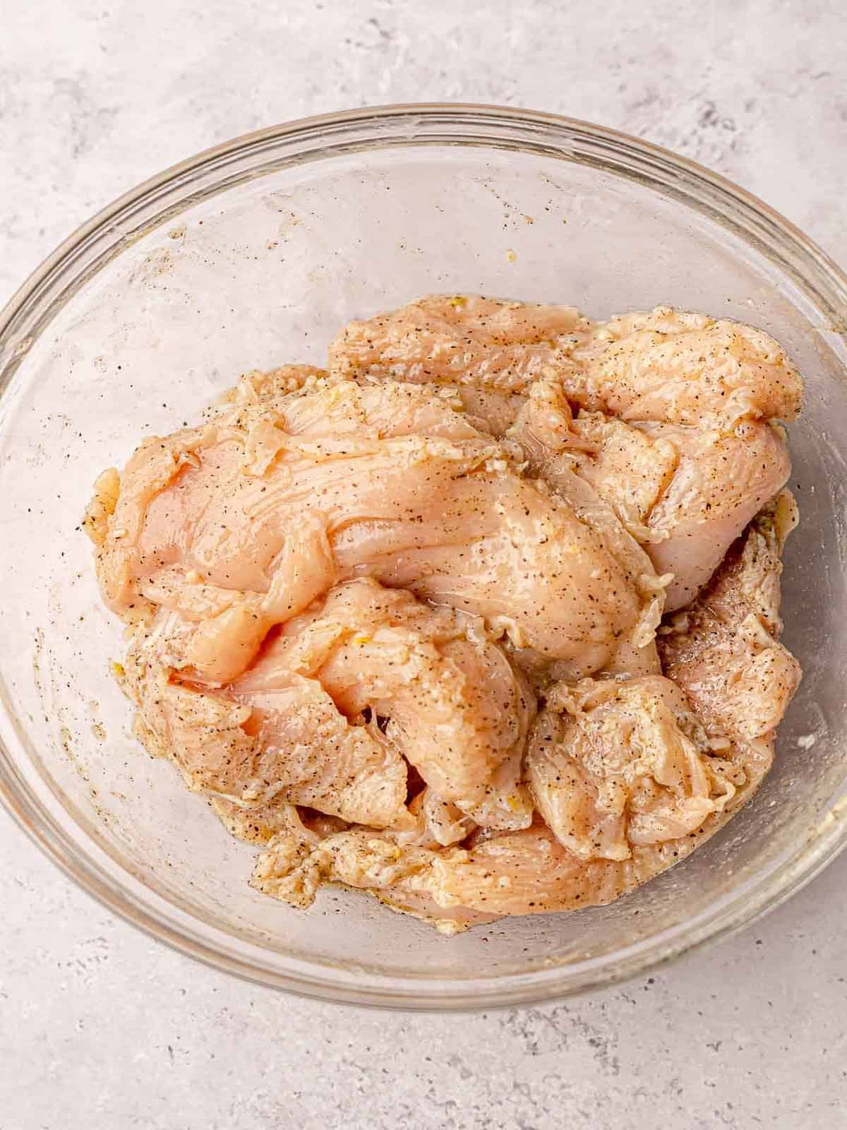 Chicken breasts in a marinade.