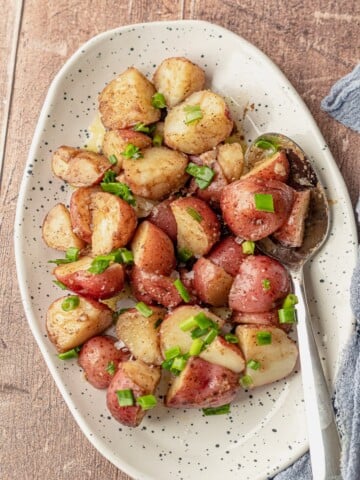 Potato salad with balsamic vinaigrette on a speckled plate.