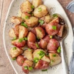 A plate of potato salad topped with chives.