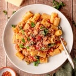 A plate of rigatoni with Italian sausage.
