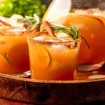 Apple cider margaritas garnished with rosemary and cinnamon sticks.