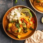 A bowl of Thai chicken curry with rice and veggies.