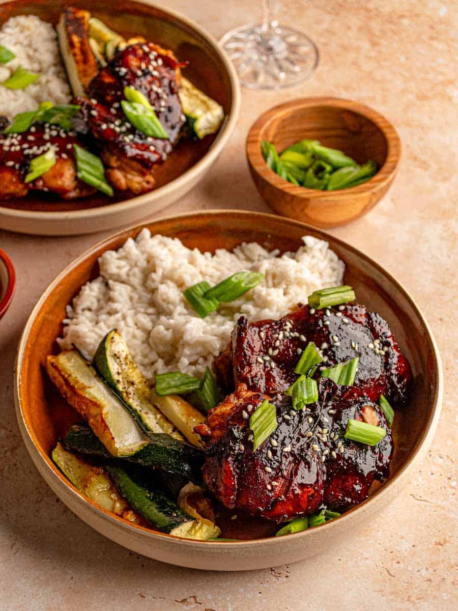 Honey garlic chicken on a plate with rice.