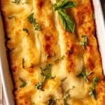 Platter of lasagna topped with basil.