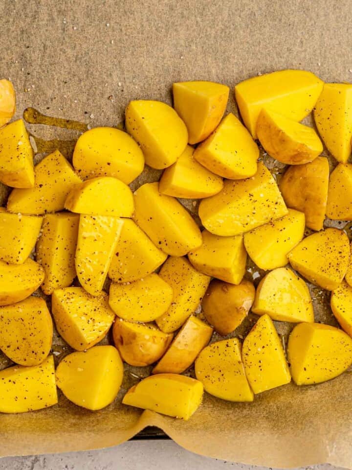 Cut yellow potatoes on parchment paper.