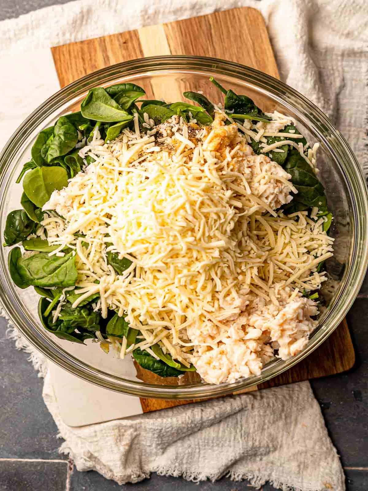 Cheese, crab and spinach in a bowl.