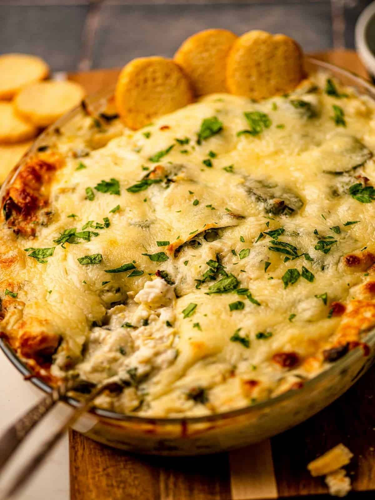 Spinach artichoke dip with two spoons dug in.