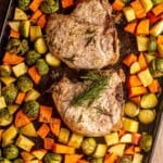 Pork chops and vegetables on a sheet pan.