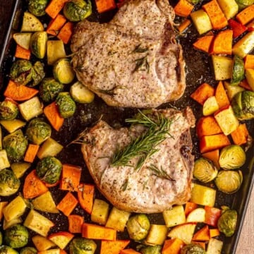 Pork chops and vegetables on a sheet pan.