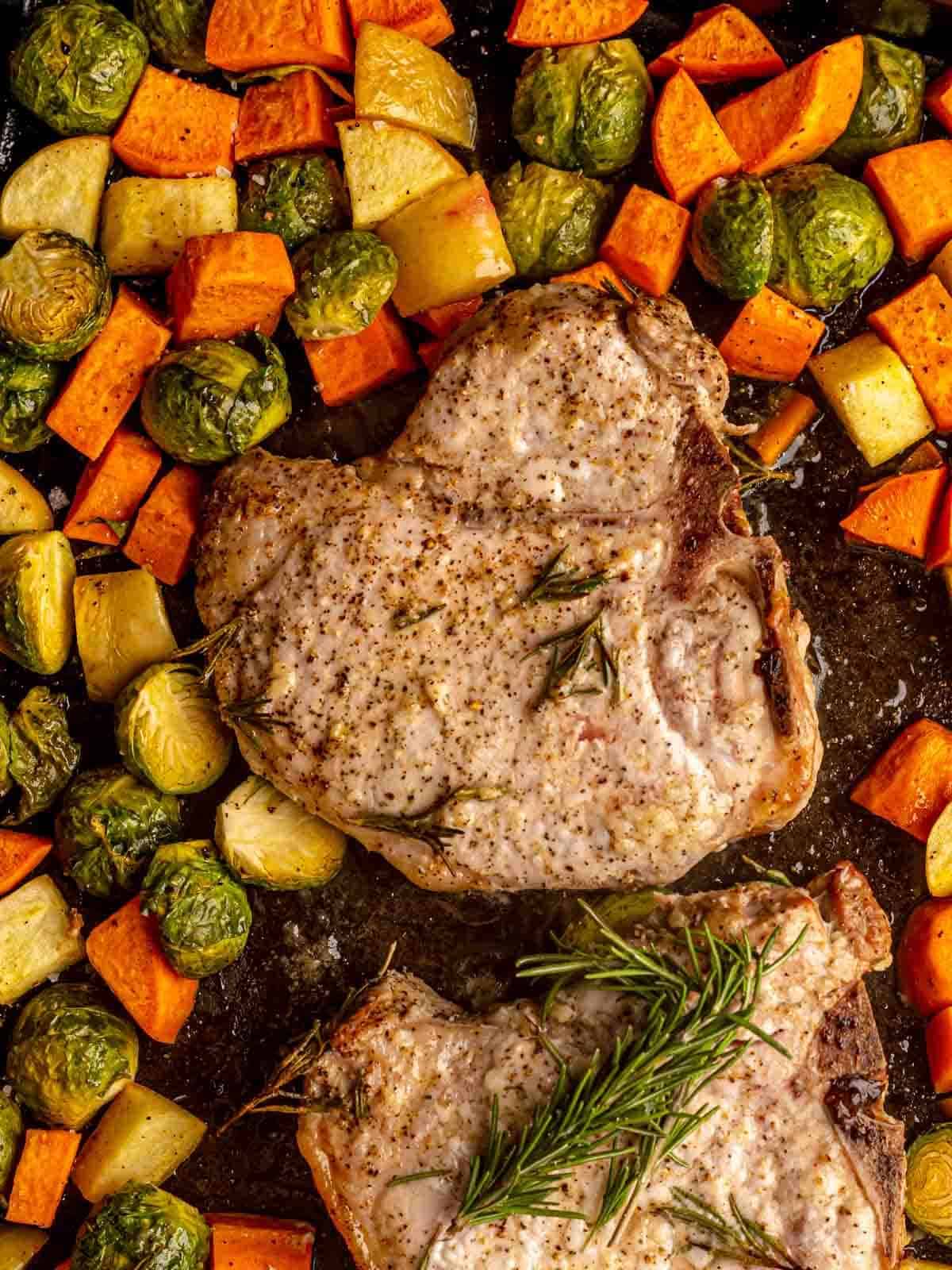Pork chops with sweet potatoes and brussels sprouts.