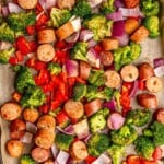 Diced sausage and vegetables on a sheet pan.