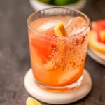 Spicy grapefruit margarita on a white coaster.