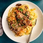 Fettuccine topped with chicken and mushrooms.