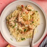 A plate of spaghetti and shrimp scampi.