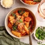 A bowl of rigatoni with sausage.
