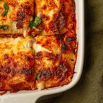 Golden and bubbly lasagna with béchamel sauce, topped with melted mozzarella and fresh basil, baked to crispy perfection.