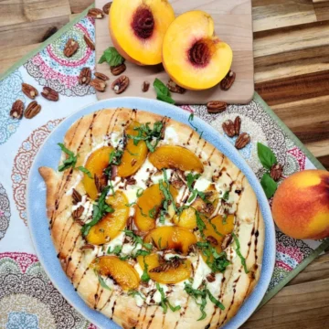 Peach slices on pizza with balsamic drizzle.