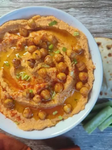 Roasted sweet potato hummus in a white bowl.