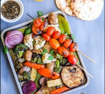 Grilled vegetables on a metal tray.