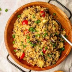 Quinoa salad in a wooden bowl with tomatoes.