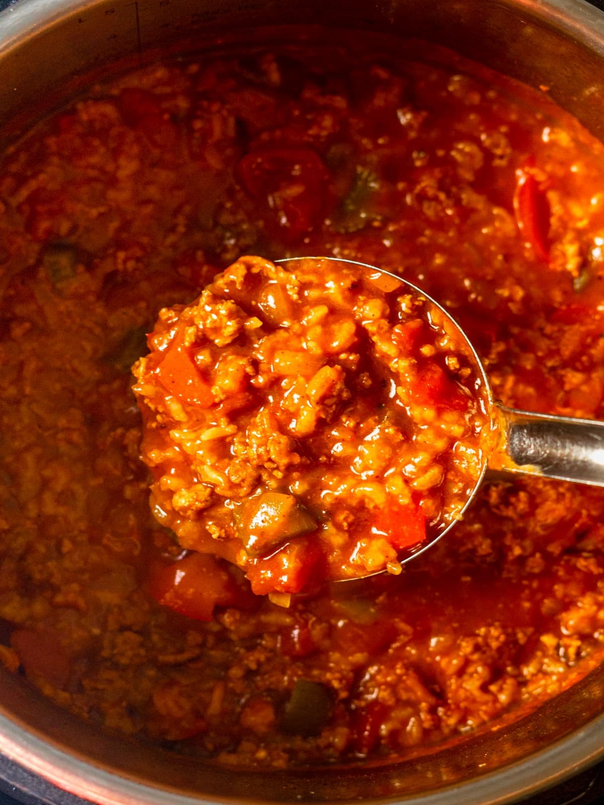 Ladle scooping up soup.