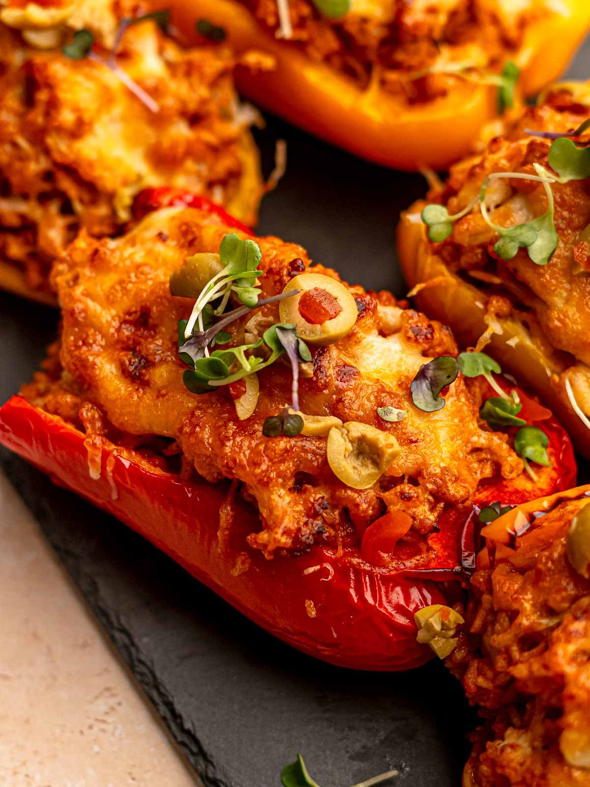 A bell pepper stuffed and topped with cheese.