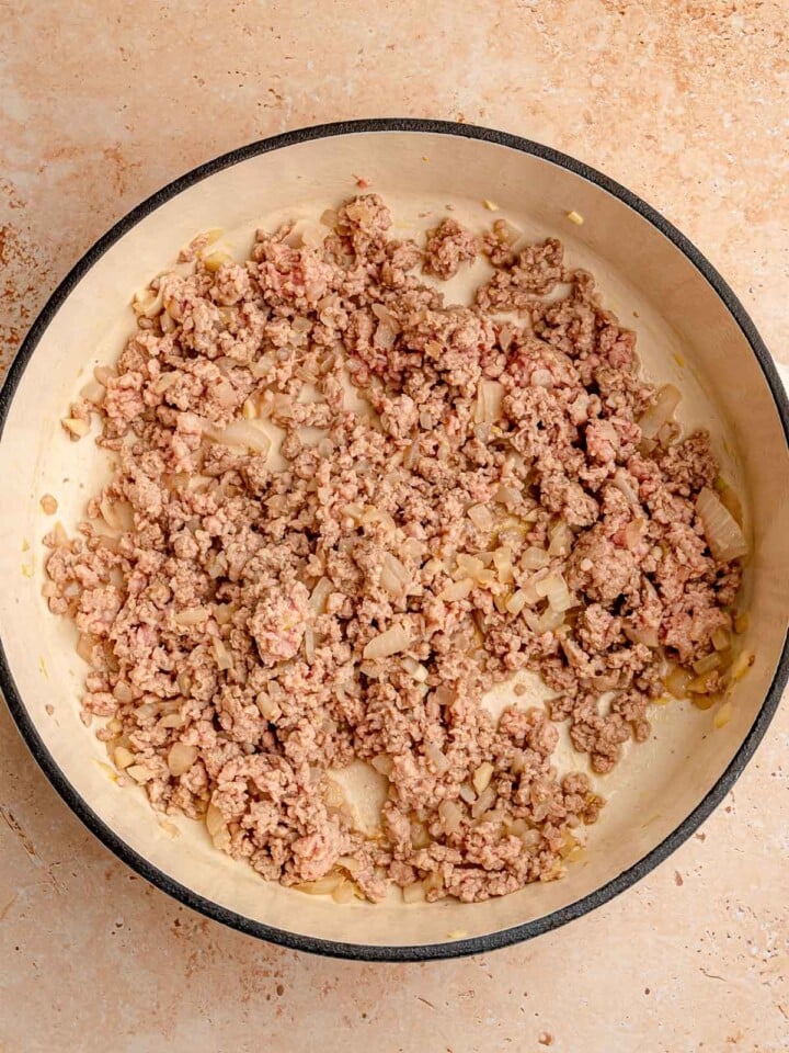 Ground pork and onion cooked in a pan.
