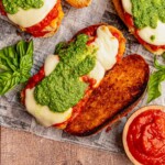Chicken parmesan sandwich topped with pesto.