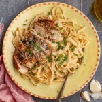 A bowl of linguine and chicken alfredo.