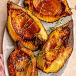 Acorn squash topped with fresh thyme.